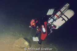 Side-mount diver mapping out the tunnel system of a flood... by Michael Grebler 